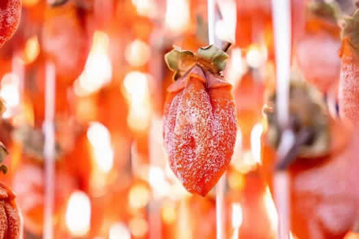Massage the persimmons until the sugar blooms